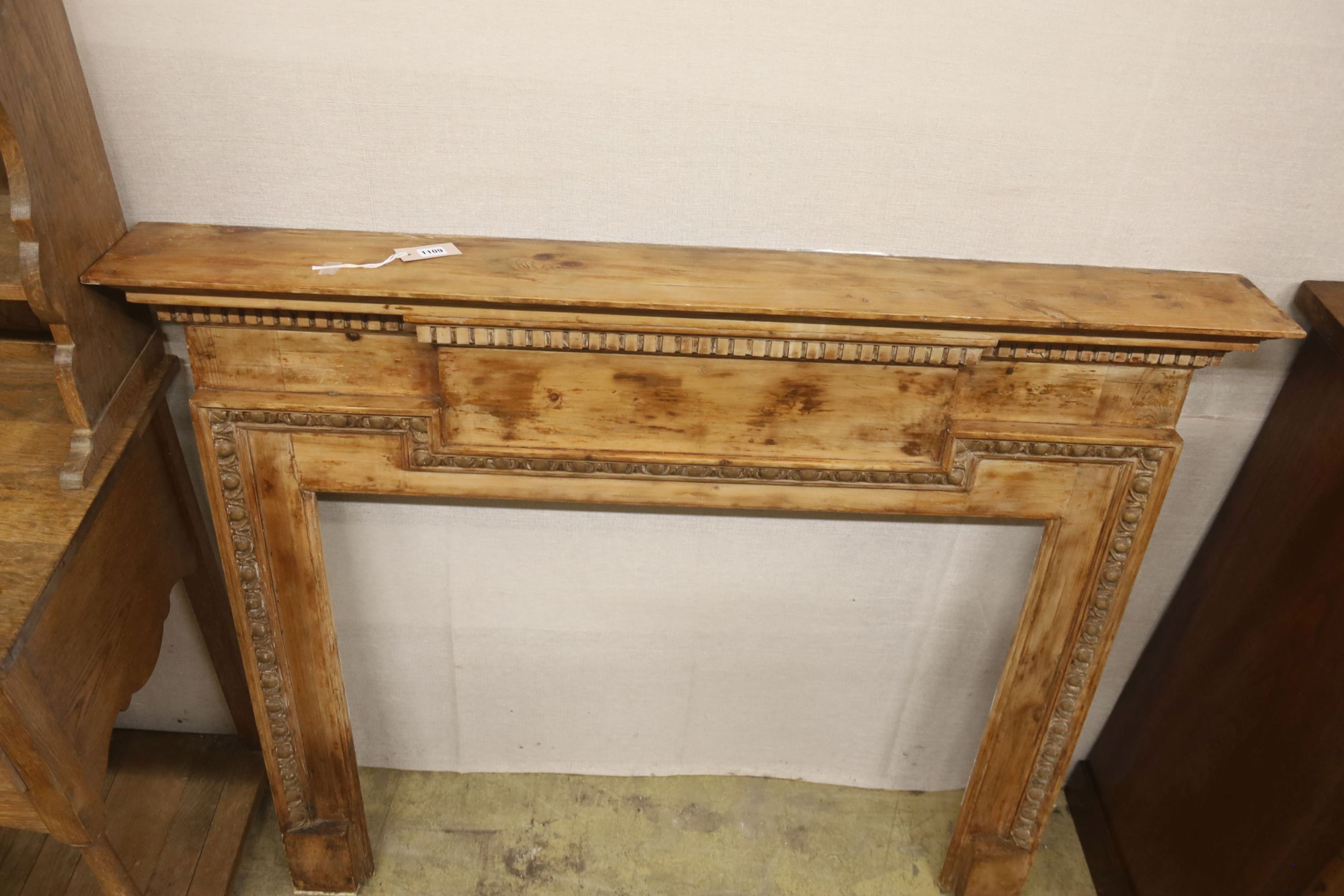 An early 20th century pine fire surround, length 135cm, height 111cm